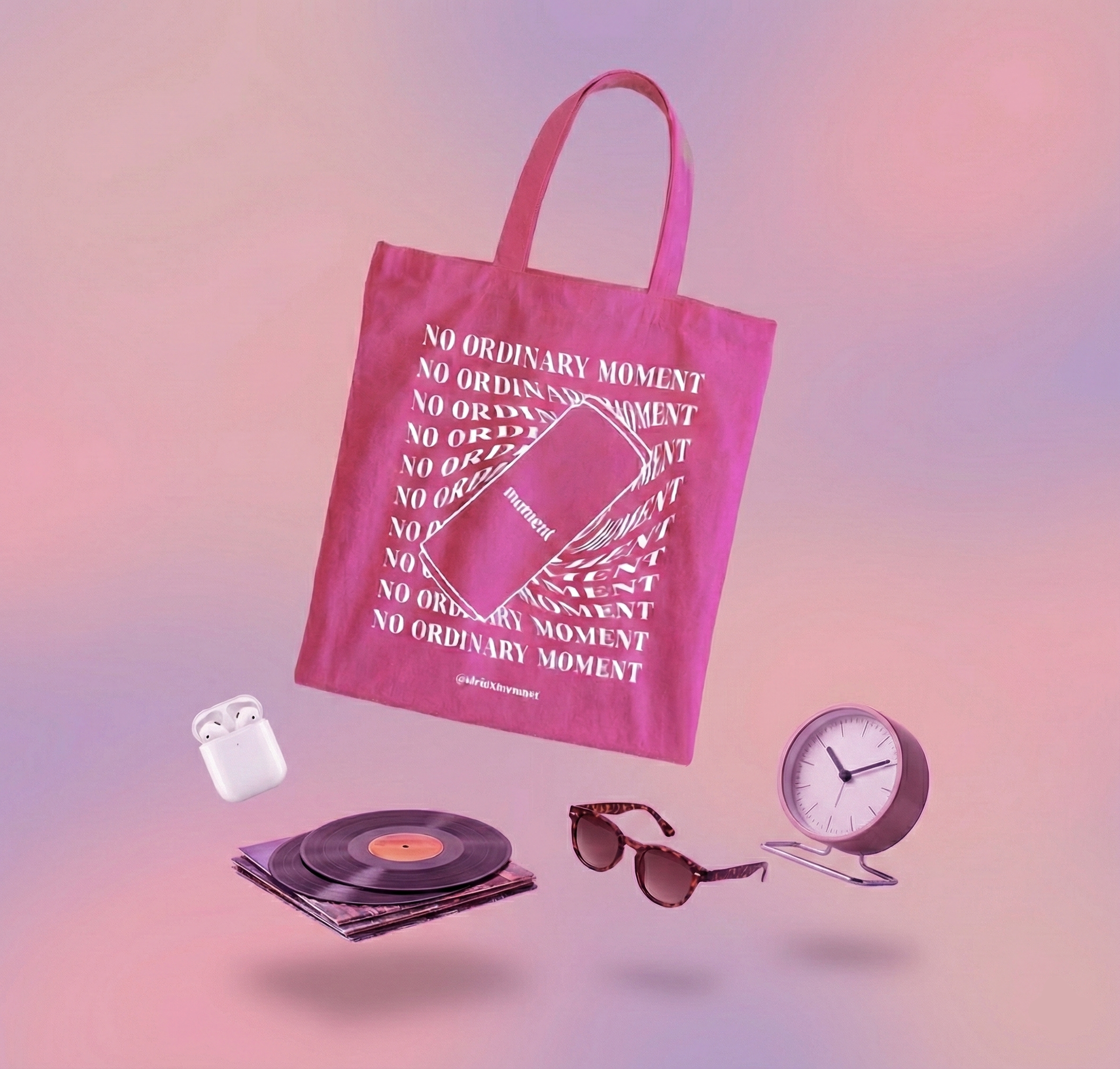 Pink tote bag with 'No Ordinary Moment' text on a gradient background