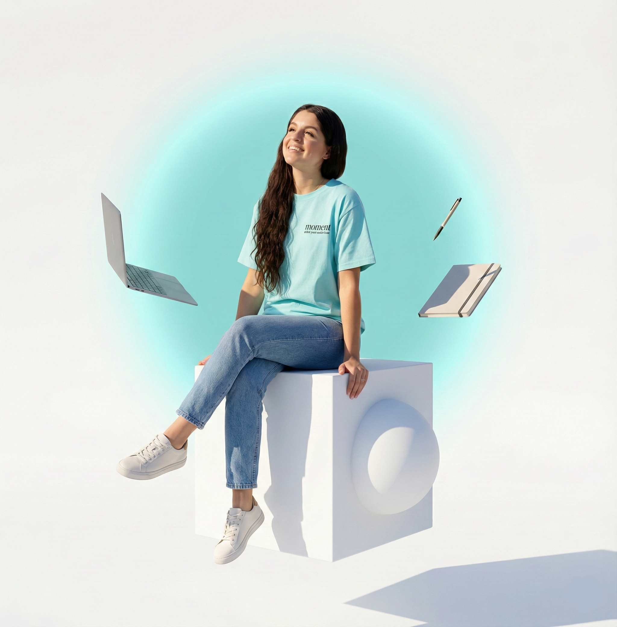 Woman sitting on a white block with laptops and a pen floating around her, wearing a light blue t-shirt.